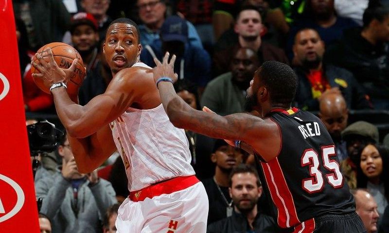 Dwight Howard of the Atlanta Hawks grabs a rebound against Willie Reed of the Miami Heat at Philips Arena on December 7, 2016