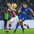 West Ham United's defender Aaron Cresswell (L) vies with Leicester City's striker Islam Slimani during an English Premier League football match at King Power Stadium in Leicester, central England on December 31, 2016