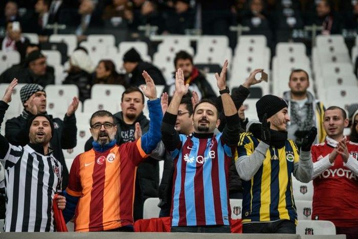 Besiktas, Fenerbahce, Galatasaray and Trabzon's supporters cheer prior to the Ziraat Turkish Cup football match between Besiktas and Kayserispor on December 14, 2016 at Vodafone arena stadium, in Istanbul