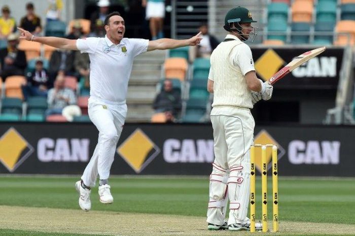 South Africa paceman Kyle Abbott (L) celebrates his wicket of Australia batsman Adam Voges (R) in Hobart on November 15, 2016