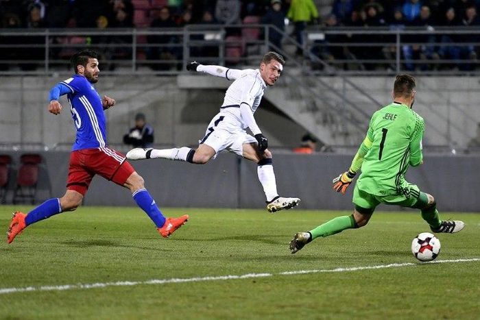 Italy's forward Andrea Belotti (C) scores past Liechtenstein's defender Michele Polverino (L) and goalkeeper Peter Jehle on November 12, 2016