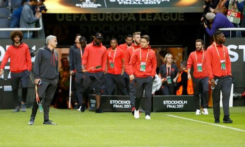 Manchester United manager Jose Mourinho (2nd L) and his players walk onto the pitch at the Friends Arena in Solna outside Stockholm on May 23, 2017, on the eve of the Europa League final against Ajax Amsterdam
