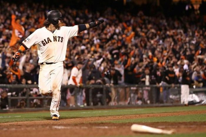 Brandon Crawford of the San Francisco Giants celebrates as he heads home to score the game winning run in the 13th inning against the Chicago Cubs on October 10, 2016 in San Francisco, California