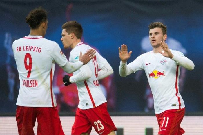 Leipzig's striker Timo Werner (R) celebrates after scoring with his teamate defender Marcel Halstenberg and forward Yussuf Poulsen (L) during the German first division Bundesliga football match against TSG Hoffenheim January 28, 2017