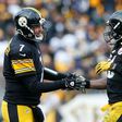 Le'Veon Bell (R) of the Pittsburgh Steelers celebrates with quarterback Ben Roethlisberger after he rushed for a touchdown against the Miami Dolphins on January 8, 2017