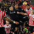 Liverpool's Roberto Firmino (L) and Joel Matip (2L) vie in the air with Southampton's Virgil van Dijk (2R) and Oriol Romeu in Southampton, on November 19, 2016