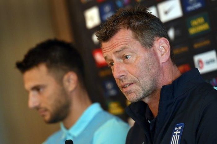 Andreas Samaris (L) rejoins the Greek national football team in the line up announced by head coach Michael Skibbe (R) tain Andreas Samaris (L) attend a press conference in Sydney on June 3, 2016.Australia play Greece in a double-header football intern...