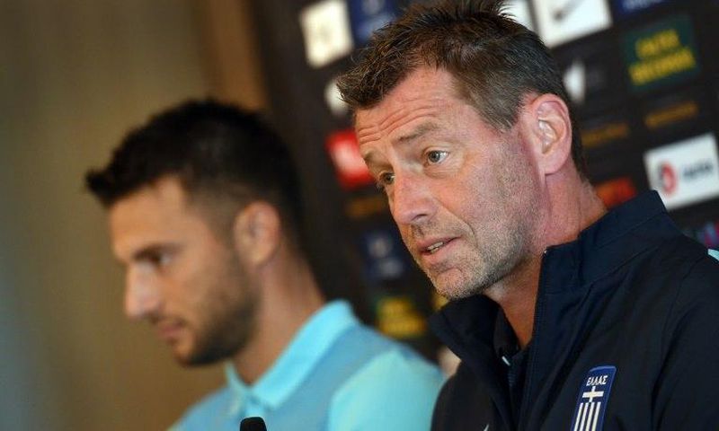 Andreas Samaris (L) rejoins the Greek national football team in the line up announced by head coach Michael Skibbe (R) tain Andreas Samaris (L) attend a press conference in Sydney on June 3, 2016.Australia play Greece in a double-header football intern...