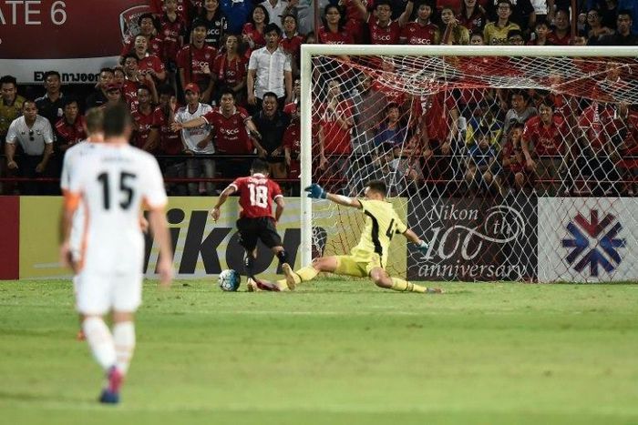 Muangthong United supporters watch intently as Chanathip Songkrasin of Muangthong United (C) rounds Brisbane Roar's goalkeeper Jamie Young to score a goal during their AFC Asian Champions League match, at the SCG Stadium in Bangkok, on April 26, 2017