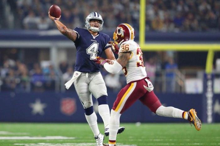 Dak Prescott of the Dallas Cowboys rolls out to pass during the fourth quarter against the Washington Redskins at AT&T Stadium