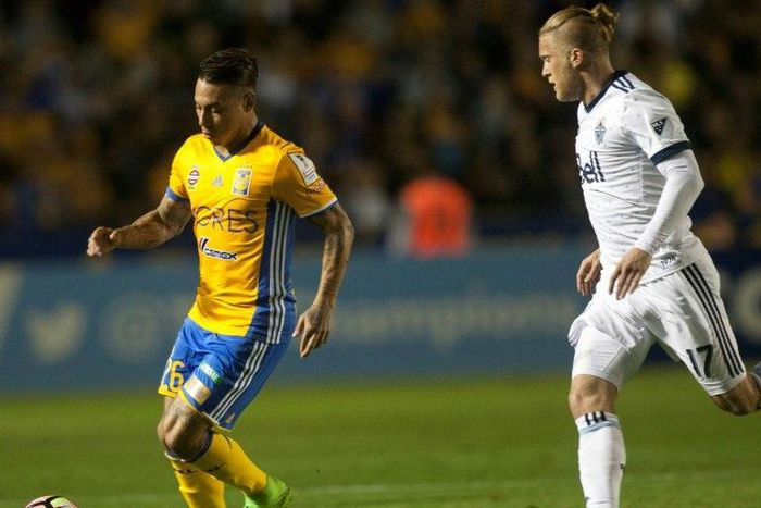 Eduardo Vargas (L) of Mexico's Tigres fights for the ball with Marcel De Jong of Canada's Vancouver Whitecaps during their CONCACAF Champions League semi-final 1st leg match, at the Universitario stadium in Monterrey, on March 14, 2017