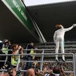 Mercedes' British driver Lewis Hamilton waves to fans after taking pole position in qualifying for the Formula One Chinese Grand Prix in Shanghai