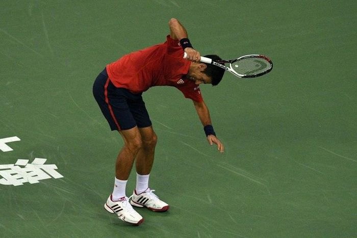 Novak Djokovic smashes his racket after losing a point against Roberto Bautista at the Shanghai Masters