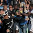 A security staff holds Lyon's goalkeeper Anthony Lopes (C) during scuffles at half-time between some of Lyon's players and Bastia supporters who invaded the pitch on April 16, 2017 in Bastia on the French Mediterranean island of Corsica