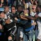 A security staff holds Lyon's goalkeeper Anthony Lopes (C) during scuffles at half-time between some of Lyon's players and Bastia supporters who invaded the pitch on April 16, 2017 in Bastia on the French Mediterranean island of Corsica