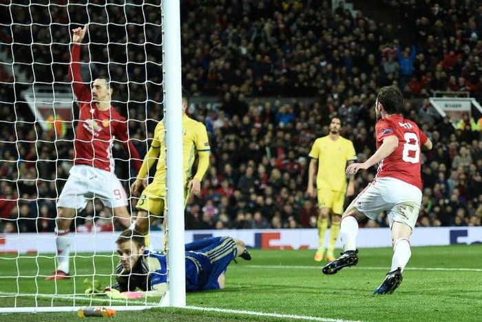 Manchester United's midfielder Juan Mata (R) celebrates after scoring the opening goal during the UEFA Europa League round of 16 second-leg football match against FC Rostov at Old Trafford stadium in Manchester, on March 16, 2017