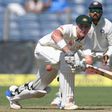 Australia's Matthew Renshaw plays a shot as India's Murali Vijay (R) watches on as during the first day of the first Test at The Maharashtra Cricket Association Stadium in Pune on February 23, 2017