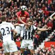Manchester United's Anthony Martial (2R) climbs above West Bromwich Albion's Craig Dawson (R) but heads wide during their match at Old Trafford on April 1, 2017