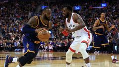 LeBron James of the Cleveland Cavaliers dribbles the ball past DeMarre Carroll of the Toronto Raptors on December 5, 2016 in Toronto, Canada