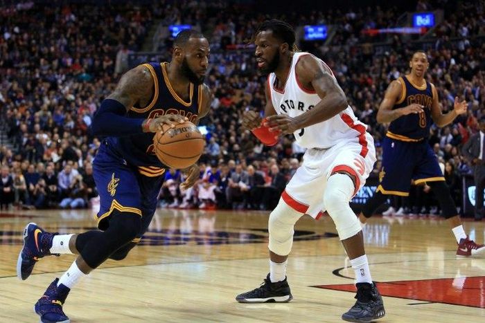 LeBron James of the Cleveland Cavaliers dribbles the ball past DeMarre Carroll of the Toronto Raptors on December 5, 2016 in Toronto, Canada