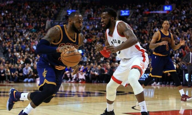LeBron James of the Cleveland Cavaliers dribbles the ball past DeMarre Carroll of the Toronto Raptors on December 5, 2016 in Toronto, Canada