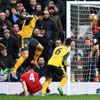 Arsenal's French striker Olivier Giroud (left) scores his team's first goal during the English Premier League match against Manchester United at Old Trafford in Manchester on November 19, 2016