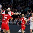 Bahrain's Mohamed Merza Salman (L) defends against Denmark'back Mikkel Hansen during their World Championship match on January 18, 2017 in Paris