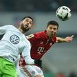 Bayern Munich's midfielder Xabi Alonso (R) and Wolfsburg's midfielder Yunus Malli vie for the ball during the German Cup DFB Pokal Round of 16 football match FC Bayern Munich v VFL Wolfburg in Munich, southern Germany on February 7, 2017