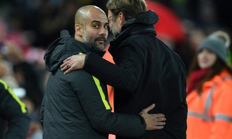 Liverpool's manager Jurgen Klopp (R) greets Manchester City's manager Pep Guardiola ahead of the English Premier League football match between Liverpool and Manchester City at Anfield in Liverpool, north west England on December 31, 2016