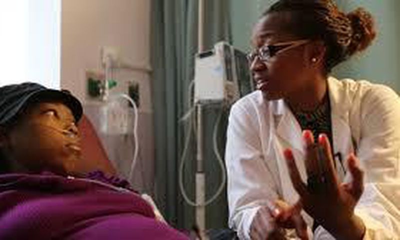 A nurse attending to a sickle cell patient.