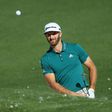 Dustin Johnson of the United States plays a shot from a bunker on the second hole at Augusta National Golf Club