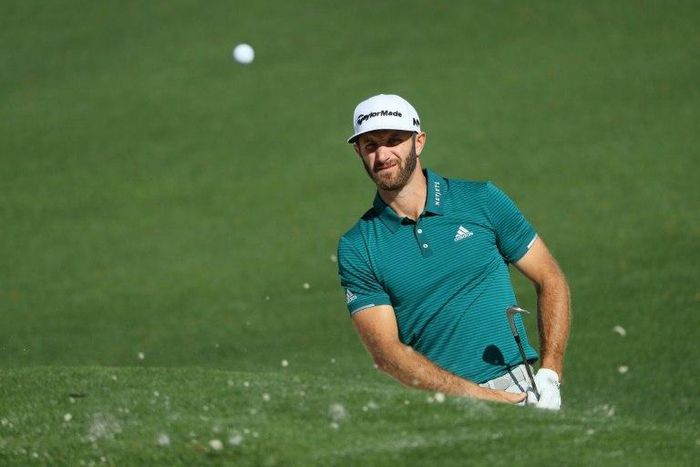 Dustin Johnson of the United States plays a shot from a bunker on the second hole at Augusta National Golf Club