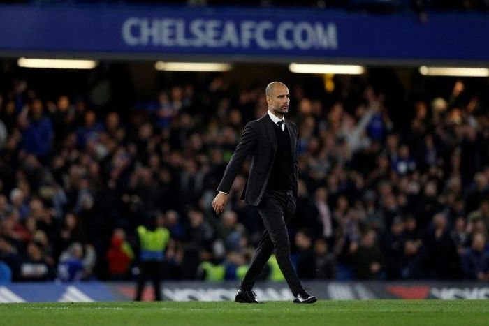 Manchester City manager Pep Guardiola crosses the pitch following his side's English Premier League match against Chelsea at Stamford Bridge in London on April 5, 2017