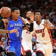 Russell Westbrook of the Oklahoma City Thunder drives on Josh Richardson (R) and Rodney McGruder of the Miami Heat during their NBA game at American Airlines Arena in Miami, Florida, on December 27, 2016