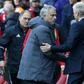 Arsenal manager Arsene Wenger shakes hands with Manchester United manager Jose Mourinho (2nd L) after Aresnal win the game 2-0