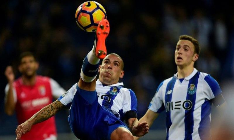 Porto's Uruguayan defender Maxi Pereira(L) in action against SC Braga: his team are chasing a Champions League spot