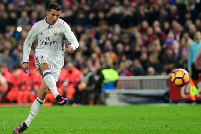 Real Madrid's forward Cristiano Ronaldo scores during the Spanish league football match against Atletico Madrid November 19, 2016