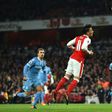 Arsenal's German midfielder Mesut Ozil (C) heads the ball to score their second goal against Stoke City at the Emirates Stadium in London on December 10, 2016