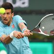 Novak Djokovic of Serbia plays a backhand against Kyle Edmund of Britain during their BNP Paribas Open second round match, at Indian Wells Tennis Garden in California, on March 12, 2017