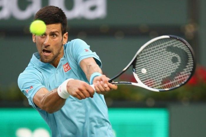 Novak Djokovic of Serbia plays a backhand against Kyle Edmund of Britain during their BNP Paribas Open second round match, at Indian Wells Tennis Garden in California, on March 12, 2017