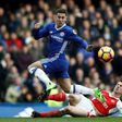 Arsenal's French defender Laurent Koscielny (R) cuts out a through ball intended for Chelsea's Belgian midfielder Eden Hazard (L) during the English Premier League football match between Chelsea and Arsenal at Stamford Bridge in London on February 4, 2...