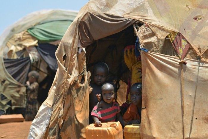 Internally displaced children pictured at the entrance of a hut at a makeshift camp on the outskirts of Baidoa, in the southwestern Bay region of Somalia, on March 14, 2017