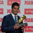 Barcelona's Uruguayan forward Luis Suarez poses after receiving the 2015-2016 Golden Shoe award to the leading goalscorer in league matches from the top division of every European national league, on October 20, 2016 in Barcelona