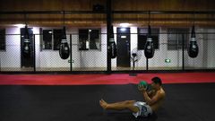 Chinese mixed martial arts (MMA) fighter Li Jingliang trains at a gym in Beijing