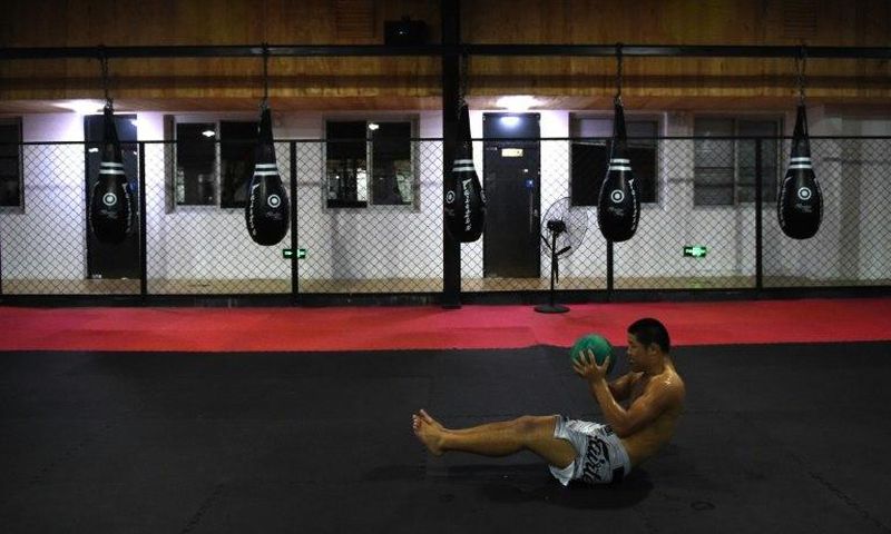 Chinese mixed martial arts (MMA) fighter Li Jingliang trains at a gym in Beijing