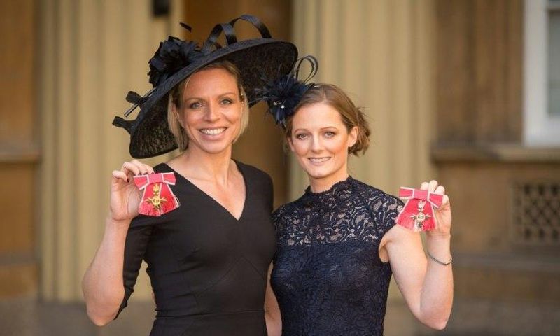 Former Great Britain hockey captain Kate Richardson-Walsh (L) and her wife Helen pose at Buckingham Palace in London after the investiture ceremony where they received an OBE and MBE respectively on February 17, 2017