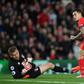 Liverpool's midfielder Philippe Coutinho (R) watches hsi shot beat Bournemouth's Polish goalkeeper Artur Boruc during the English Premier League football match between Liverpool and Bournemouth at Anfield in Liverpool, on April 5, 2017
