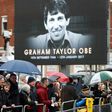 Wellwishers wait outside the church before the funeral service of former England and Watford manager Graham Taylor in Watford on February 1, 2017
