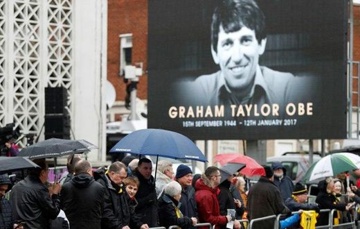 Wellwishers wait outside the church before the funeral service of former England and Watford manager Graham Taylor in Watford on February 1, 2017
