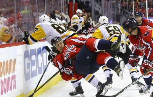 Sidney Crosby (No. 87) of the Pittsburgh Penguins checks T.J. Oshie of the Washington Capitals in Game Five of the NHL Eastern Conference 2nd round, at the Verizon Center in Washington, DC, on May 6, 2017